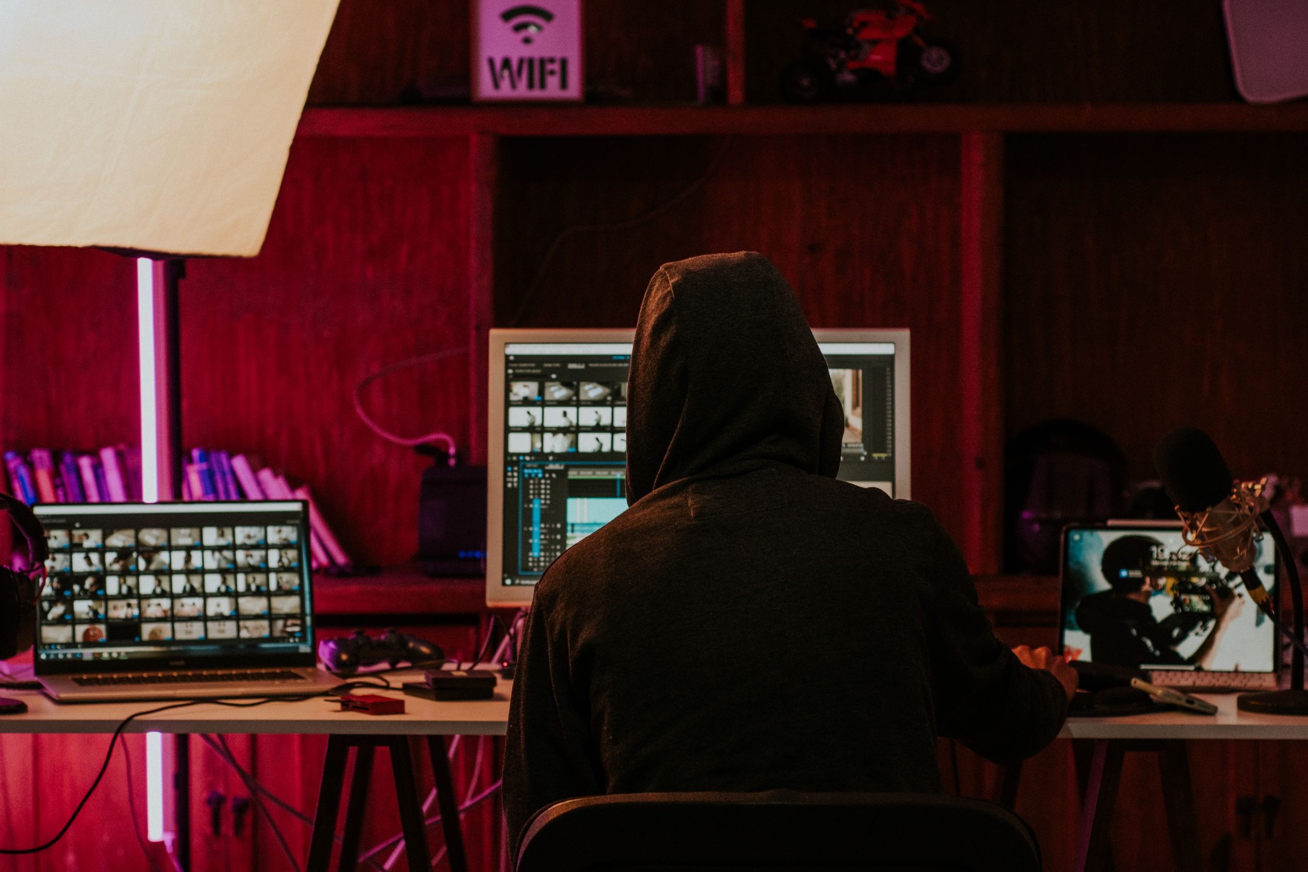 Man Wearing Hoodie and Using Computers