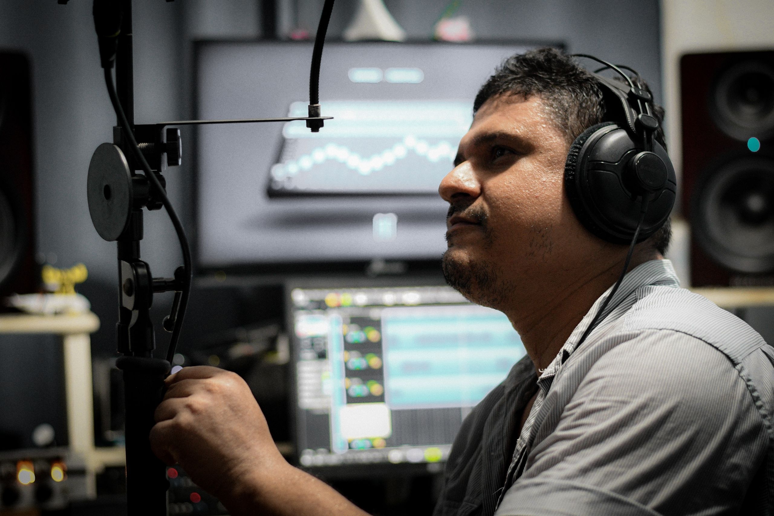 Sound Engineer in Studio Headphones with Professional Setup